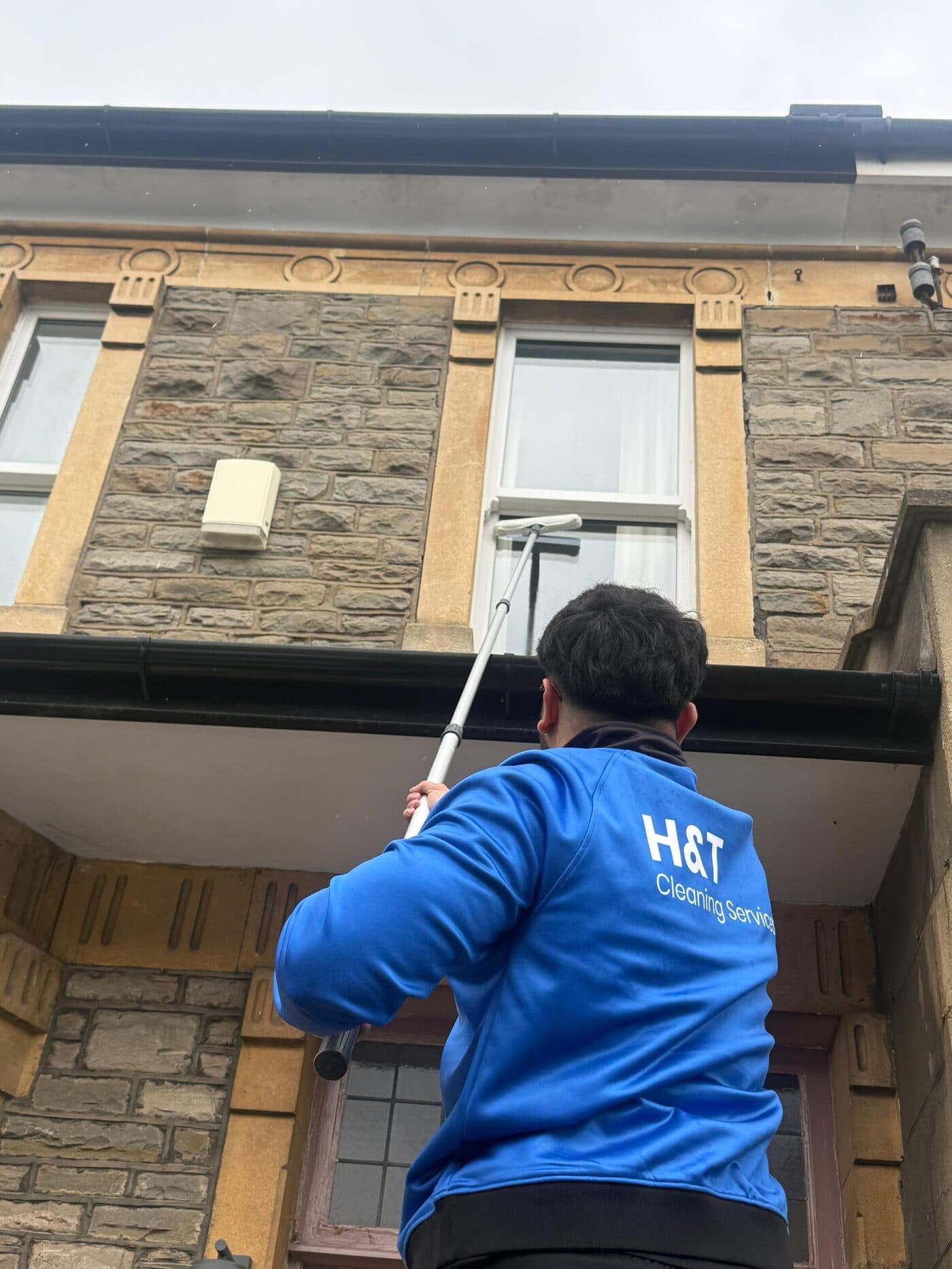 H&T technician cleaning exterior windows